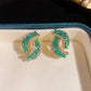 Modne kolczyki z zielonymi kryształami z krzyżykiem
